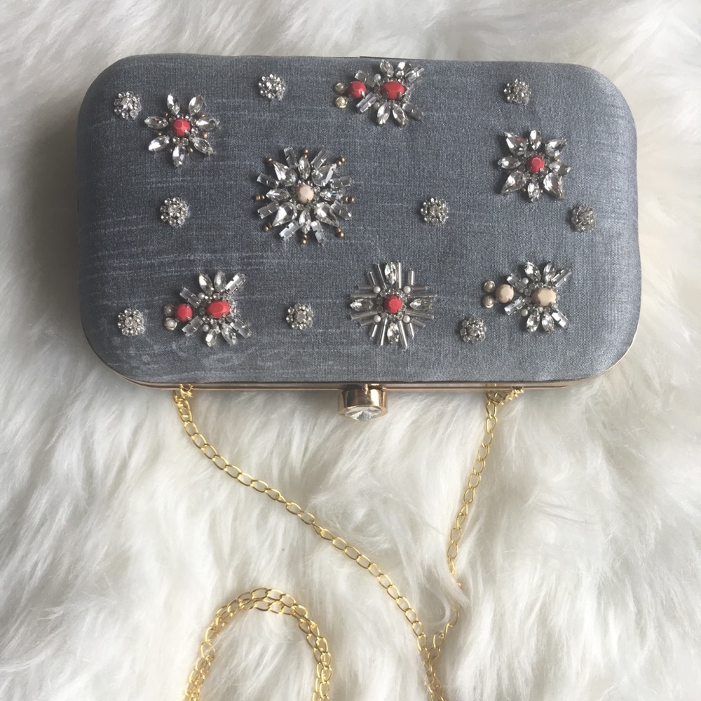 Grey clutch with white and red stones